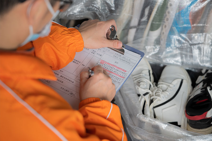 inspector taking a list of the used shoe pair's details 2