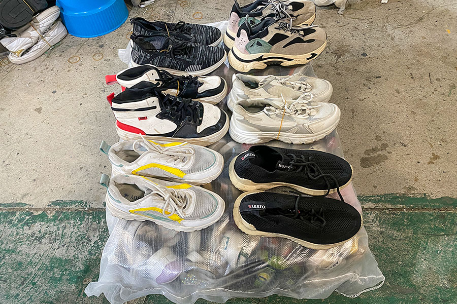 set of six men's used shoes on top of a used shoes bale